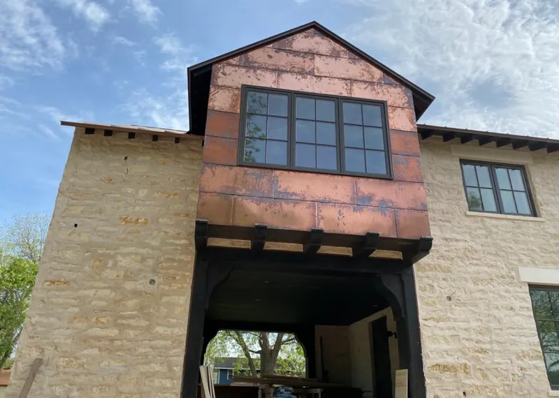 Copper metal panel facade on a stone building for Skylight Installation in Miramar Beach